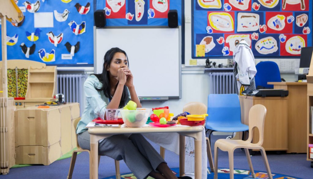 Teacher sitting at desk